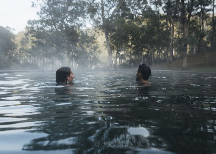 Couple enjoying a dip in the natural thermal springs in the Yarrongobilly area, Kosciuszko National Park