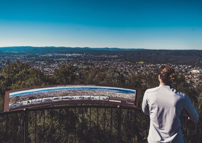 Woman enjoying views overlooking the historic town of Queanbeyan from Mount Jerrabomberra Lookout, Queanbeyan