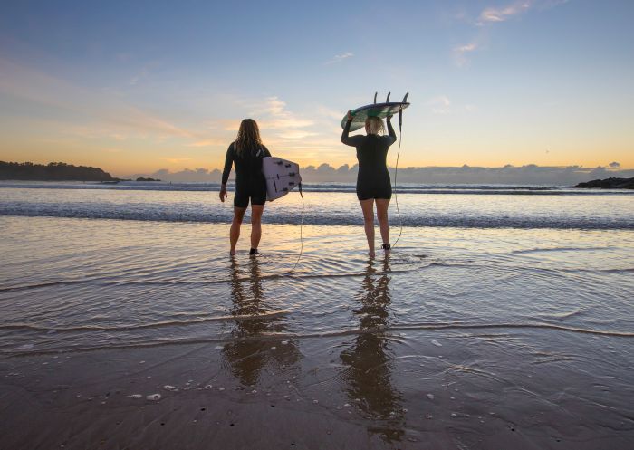 Surfers enjoying the sunset before a morning surf at Diggers Beach, Coffs Harbour