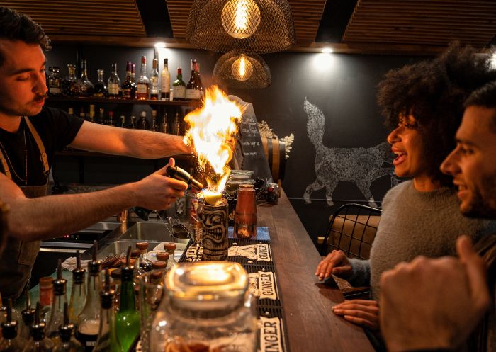 Friends watching a bartender create a cocktail at Bootlegger Bar, Katoomba