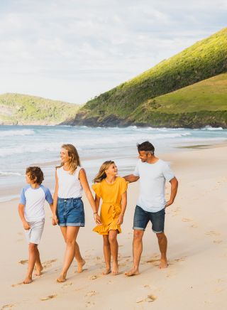 Family enjoying a walk along Blueys Beach, Blueys Beach