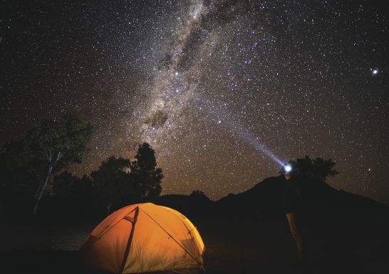 Camper gazing up at the galaxy of stars, Warrumbungles